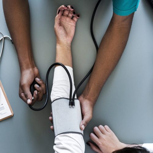 Nurse measuring patient blood pressure